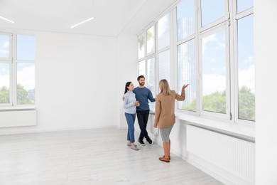 Real estate agent showing new apartment to couple