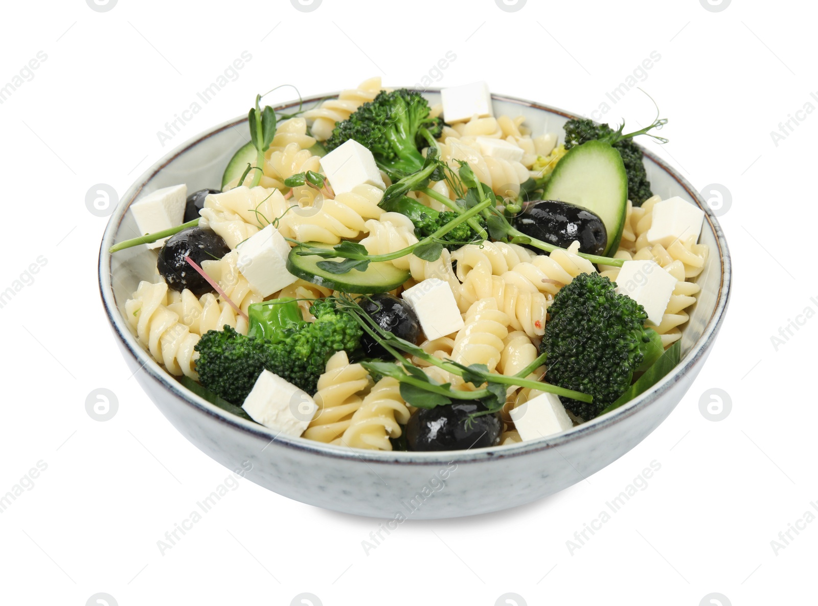 Photo of Bowl of delicious pasta with cucumber, olives, broccoli and cheese on white background