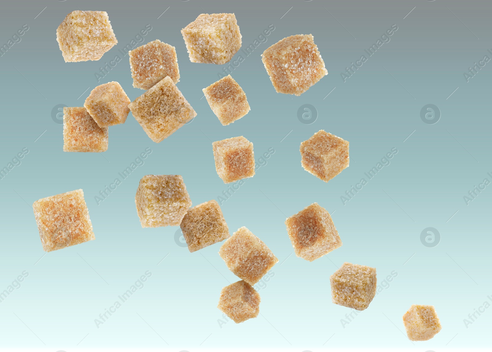 Image of Brown cane sugar cubes falling on color gradient background