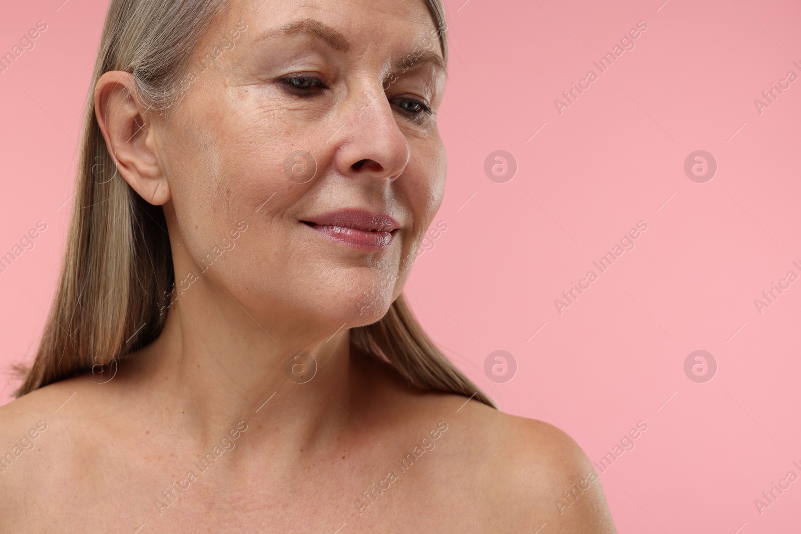 Photo of Beautiful woman with healthy skin on pink background, space for text