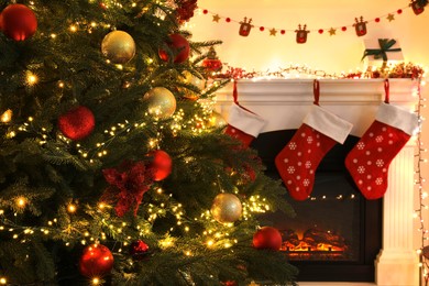 Photo of Christmas decor in living room with fireplace. Interior design