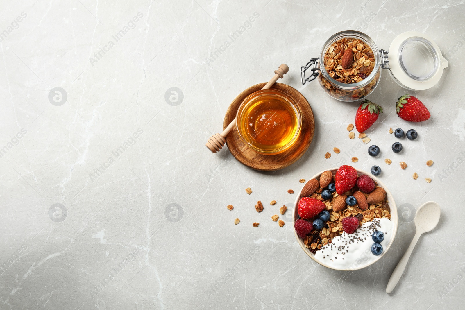 Photo of Tasty homemade granola served on marble table, flat lay with space for text. Healthy breakfast