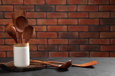 Photo of Set of different kitchen utensils on grey table, space for text