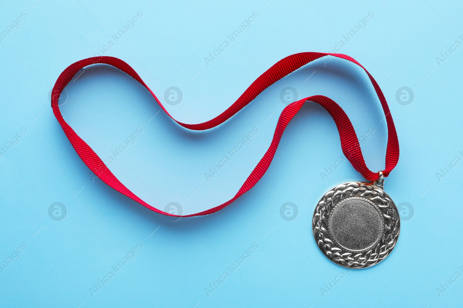 Photo of Gold medal with space for design on color background, top view. Victory concept