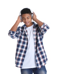 Photo of African-American teenage boy listening to music with headphones on white background