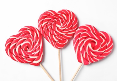 Sweet heart shaped lollipops on white background, flat lay. Valentine's day celebration