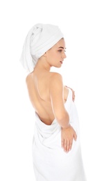 Young woman with soft towels on white background