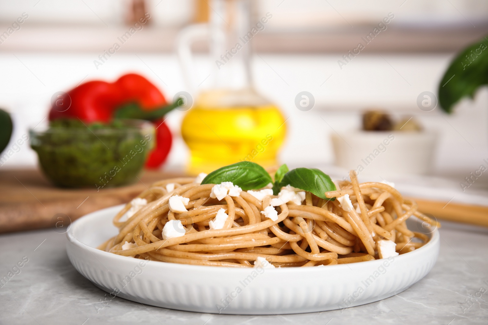 Photo of Tasty buckwheat noodles served on light grey table