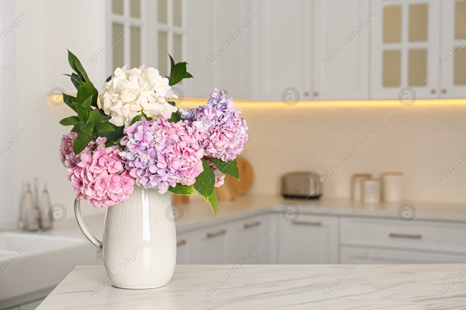 Photo of Bouquet with beautiful hydrangea flowers on white marble table. Space for text