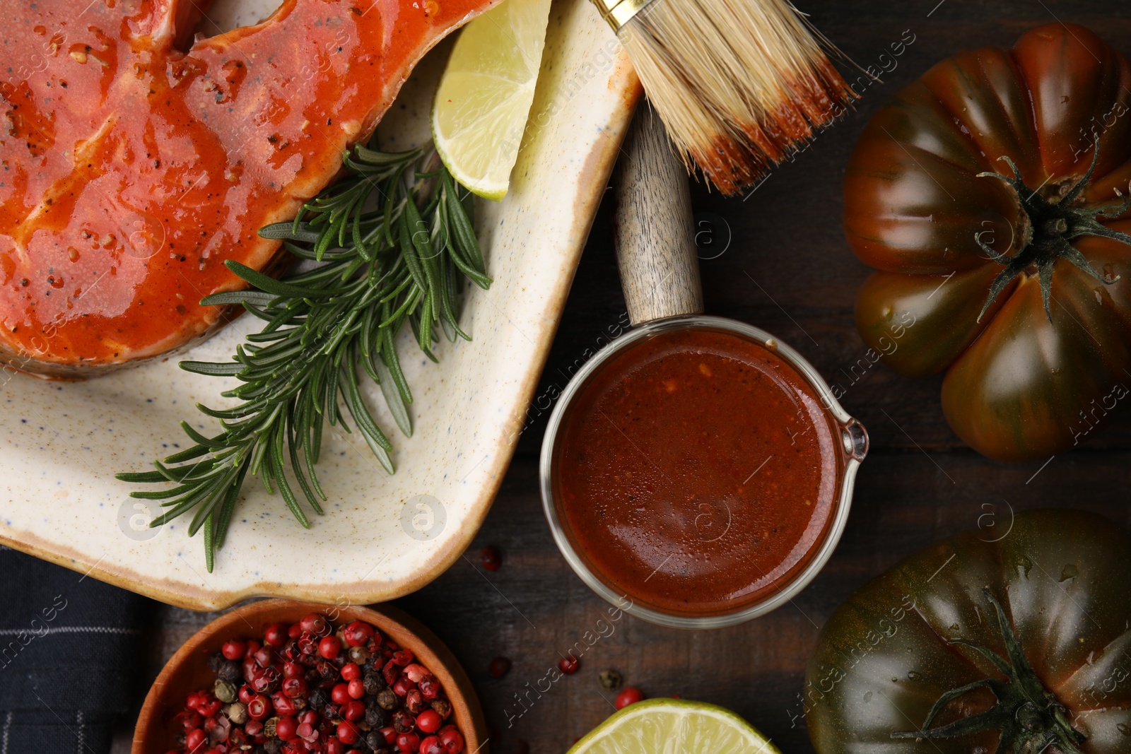 Photo of Fresh marinade, fish and other products on wooden table, flat lay