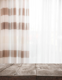 Image of Empty wooden table in room. Space for design