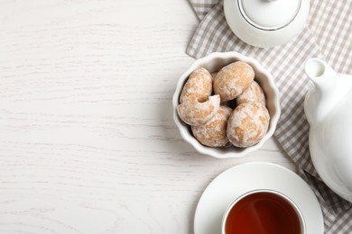 Photo of Tasty homemade gingerbread cookies and tea on white wooden table, flat lay. Space for text