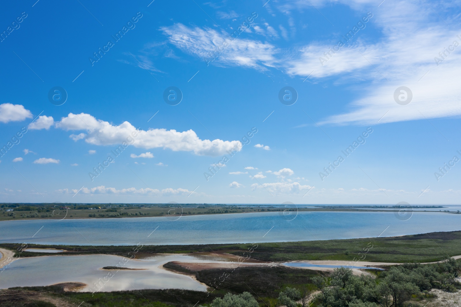 Image of Beautiful aerial view of shoreline landscape on sunny day