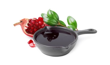 Photo of Tasty pomegranate sauce in bowl, branch and cut fruit isolated on white