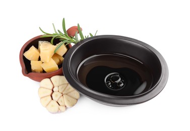 Photo of Bowl of balsamic vinegar with oil, parmesan cheese, rosemary and garlic on white background