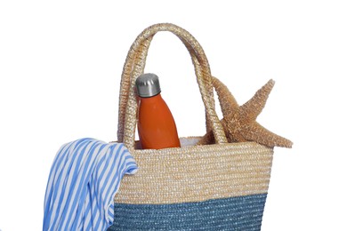Photo of Beach bag with thermo bottle, shirt and starfish isolated on white