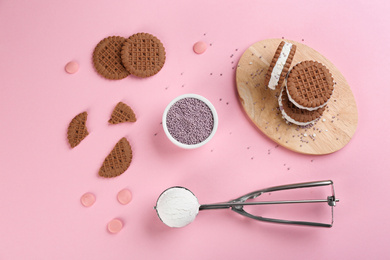 Photo of Sweet delicious ice cream cookie sandwiches on pink background, flat lay