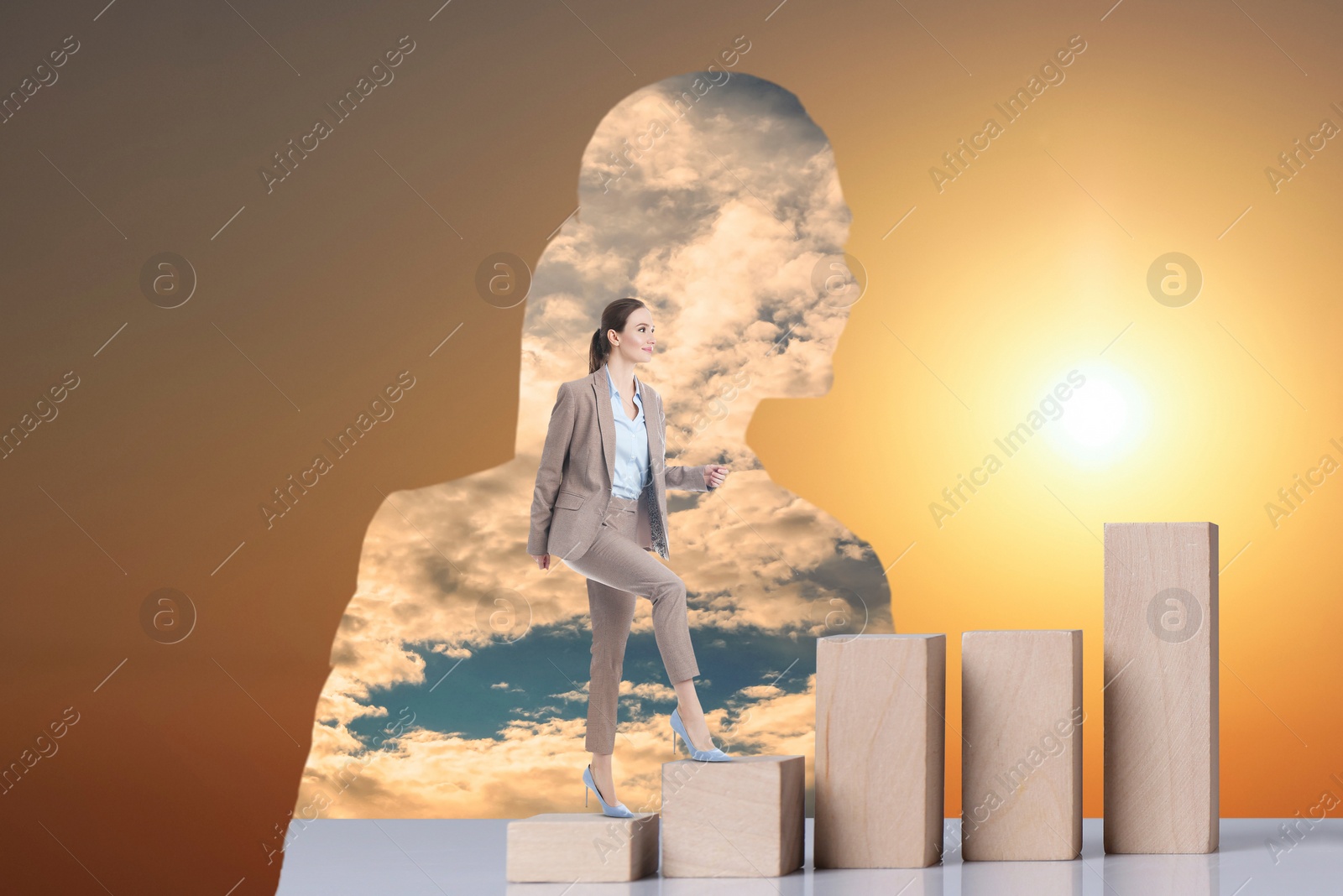 Image of Thinking about steps to success. Businesswoman climbing up stairs of wooden blocks inside of woman's silhouette