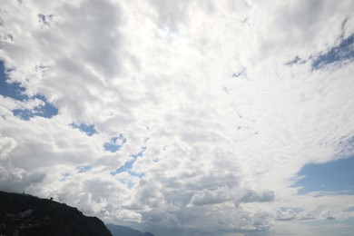 Picturesque view of mountain under beautiful sky with fluffy clouds