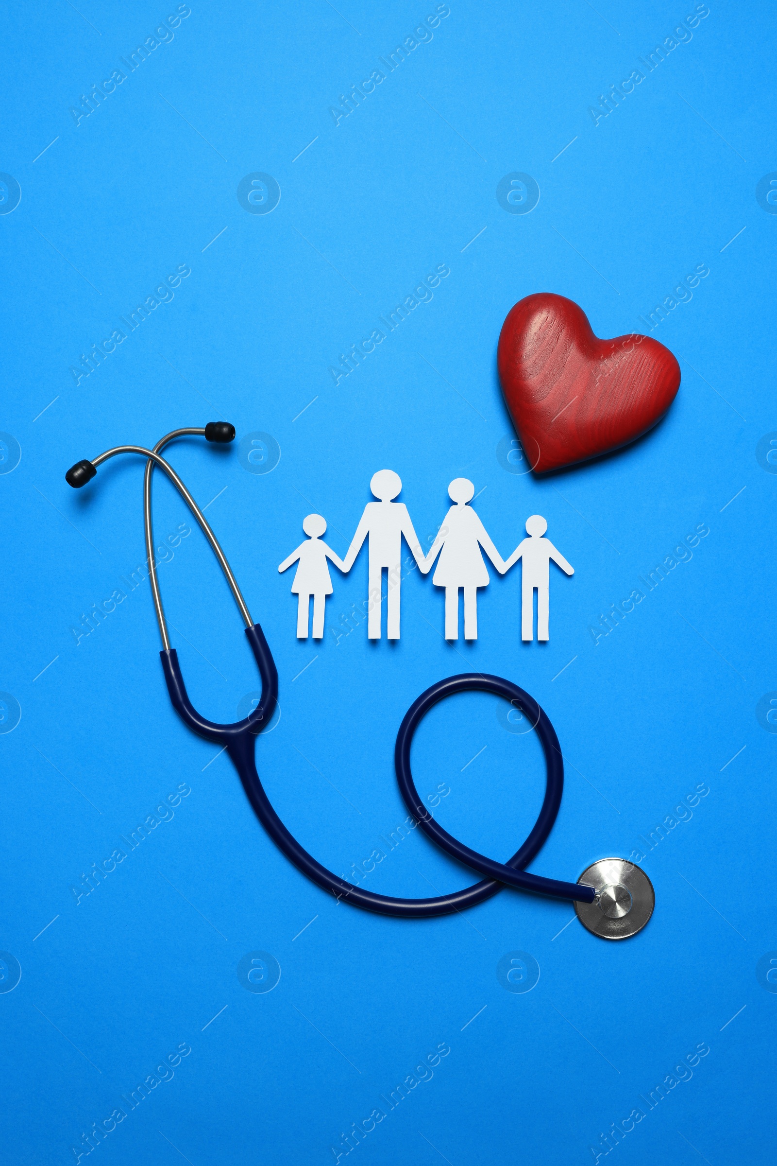 Photo of Paper family cutout, stethoscope and red heart on light blue background, flat lay. Insurance concept