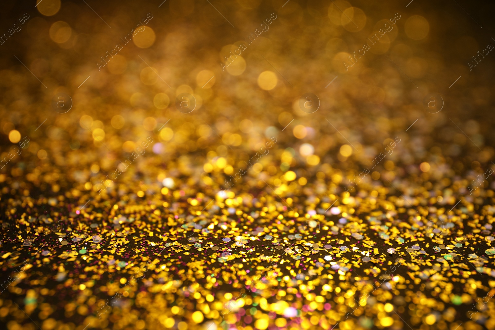 Photo of Shiny golden glitter as background. Bokeh effect