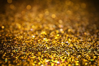 Photo of Shiny golden glitter as background. Bokeh effect