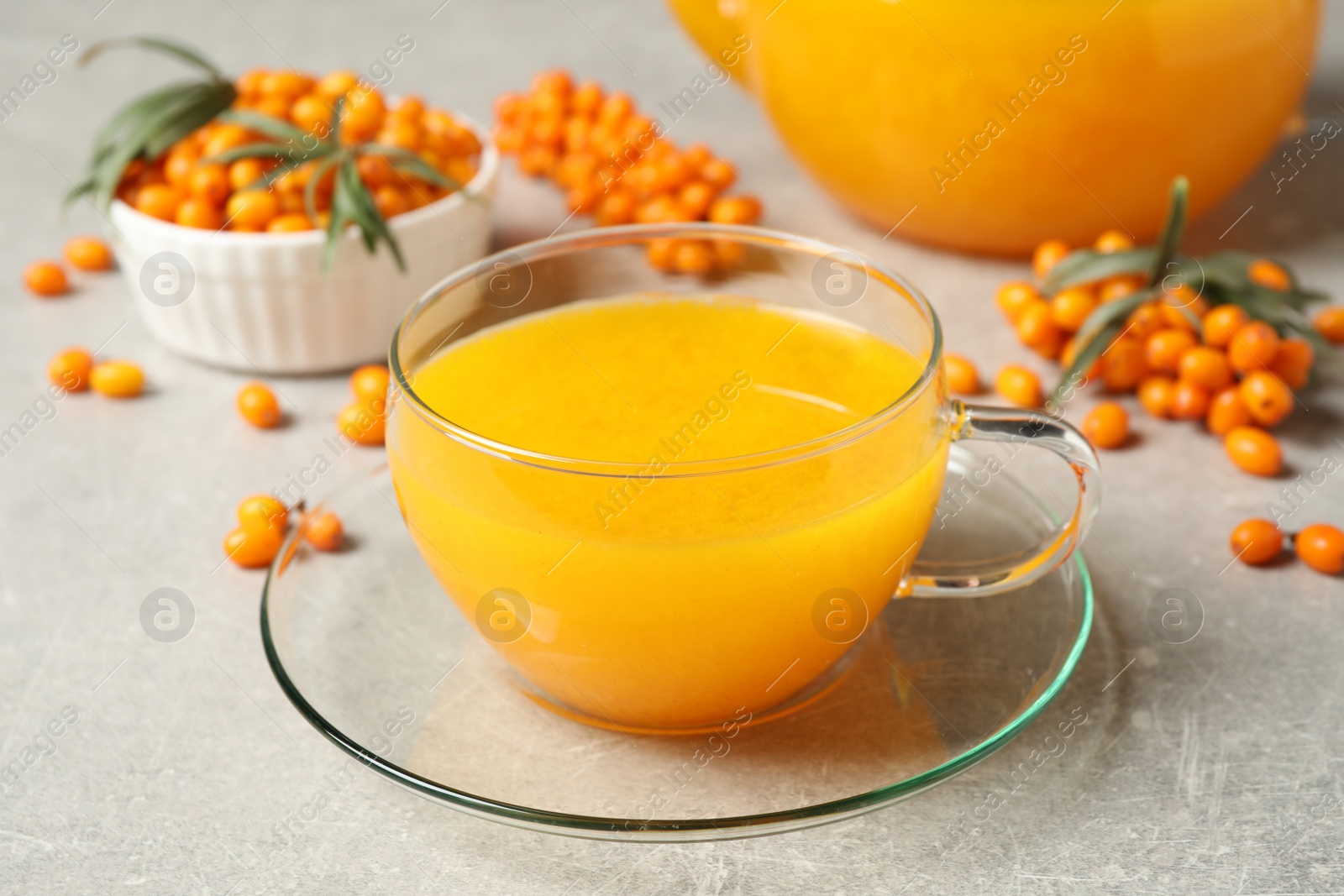 Photo of Fresh sea buckthorn tea on light table, closeup