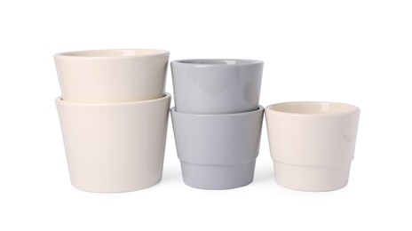 Photo of Many different empty ceramic flower pots on white background