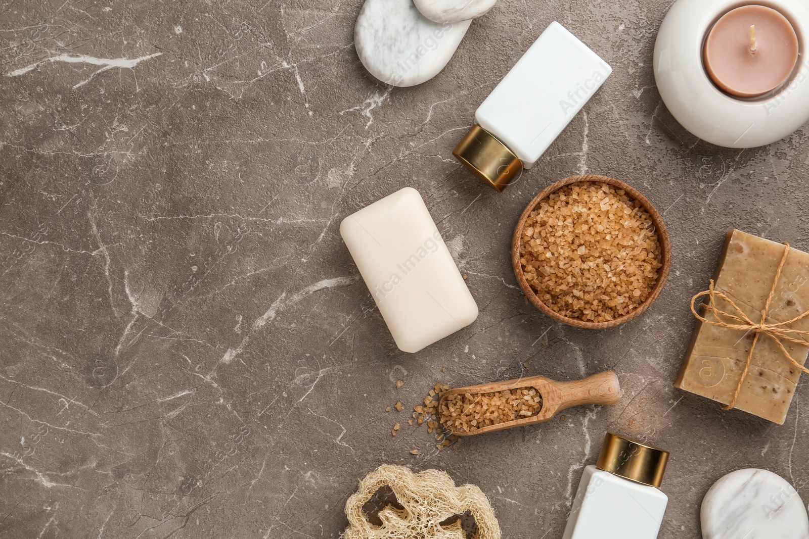 Photo of Flat lay composition with spa supplies on stone table. Space for text