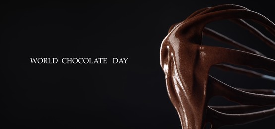 Image of World Chocolate Day. Whisk with yummy chocolate cream on black background, closeup. Banner design
