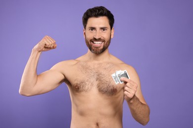 Photo of Naked man holding condoms on purple background. Safe sex