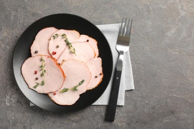 Photo of Delicious cut ham with thyme and peppercorns on grey table, flat lay
