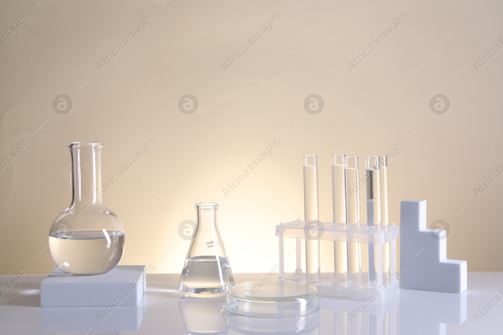 Photo of Laboratory analysis. Different glassware on table against beige background