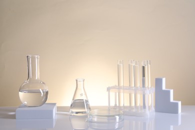 Photo of Laboratory analysis. Different glassware on table against beige background