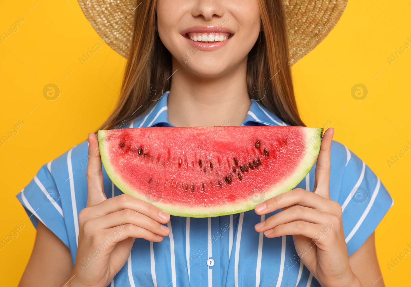Photo of Beautiful girl with slice of watermelon on yellow background, closeup