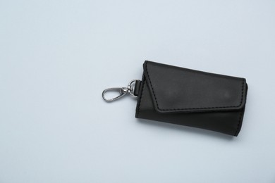 Stylish leather keys holder on light grey background, top view. Space for text