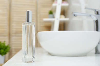 Bottle of air freshener on counter in bathroom