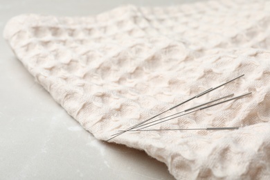 Acupuncture needles on towel, closeup. Alternative medicine