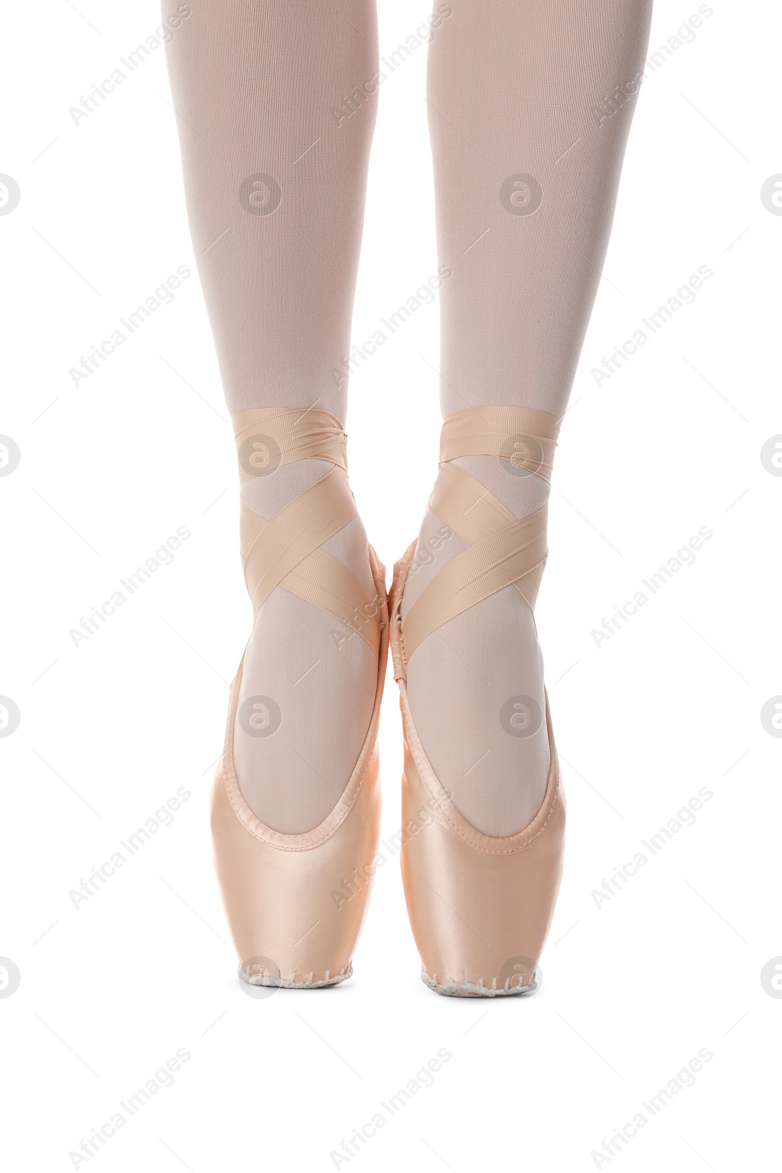 Photo of Ballerina in pointe shoes dancing on white background, closeup