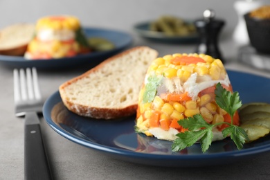 Delicious fish aspic served on grey table, closeup