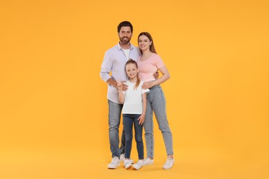 Photo of Portrait of happy family on orange background