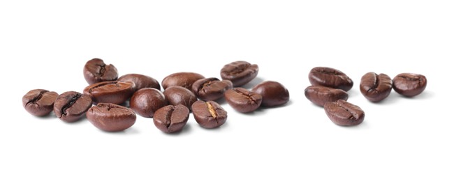 Photo of Many roasted coffee beans isolated on white