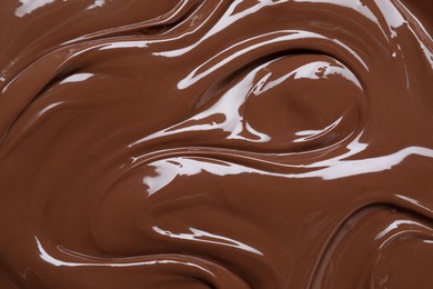 Photo of Tasty chocolate paste as background, closeup view