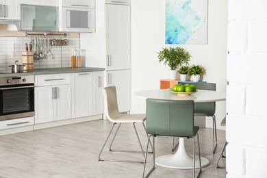 Stylish kitchen interior with dining table and chairs