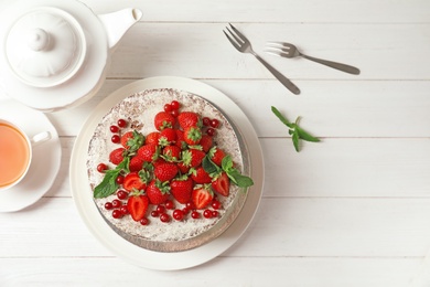 Photo of Delicious homemade cake with fresh berries on wooden table, top view