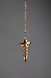 Stylish pendulum on grey background. Hypnotherapy session