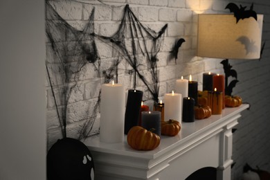 Fireplace with different Halloween decor indoors. Festive interior