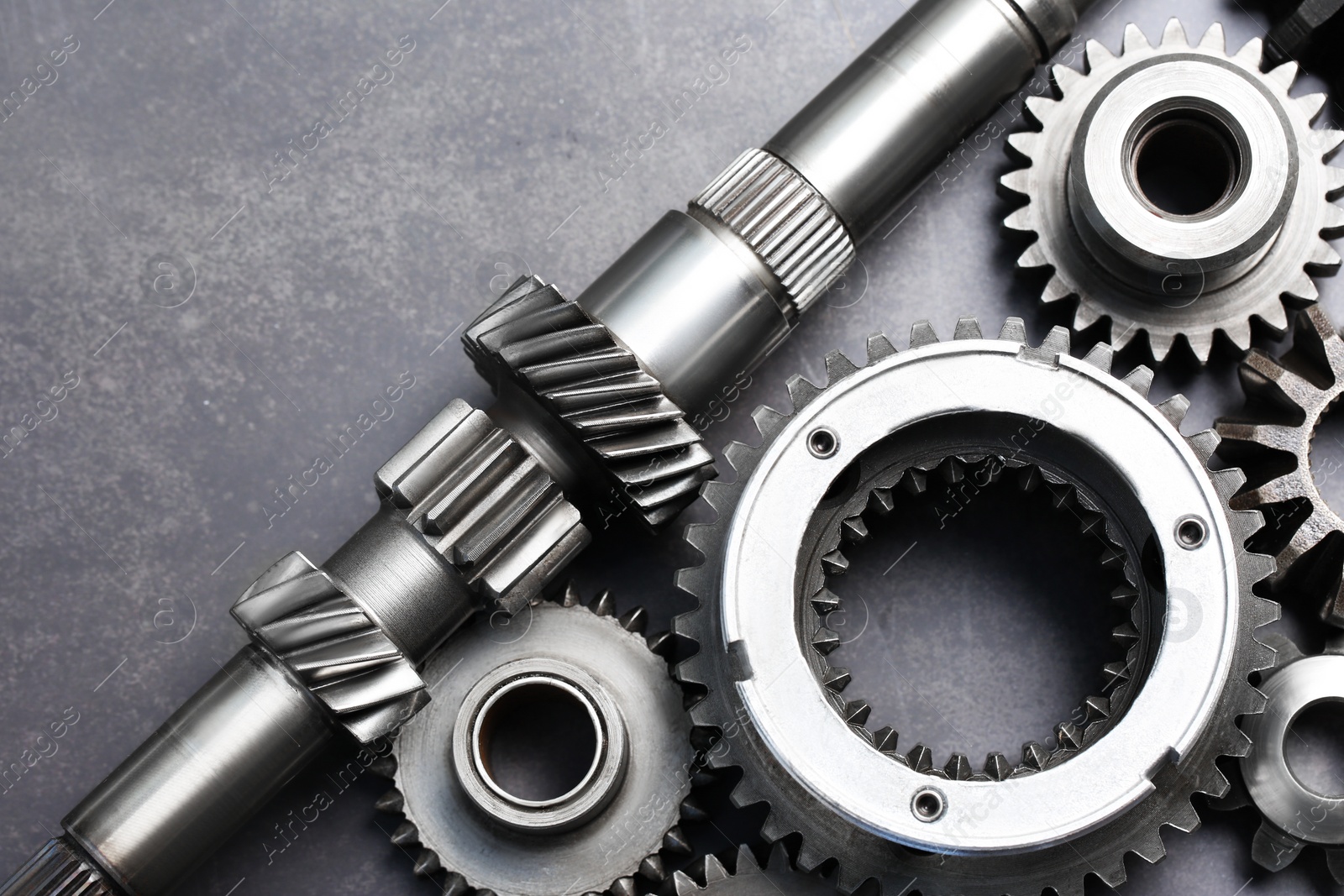 Photo of Different stainless steel gears on grey background, flat lay