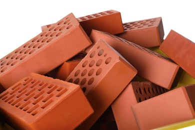 Photo of Pile of red bricks on white background, closeup. Building material