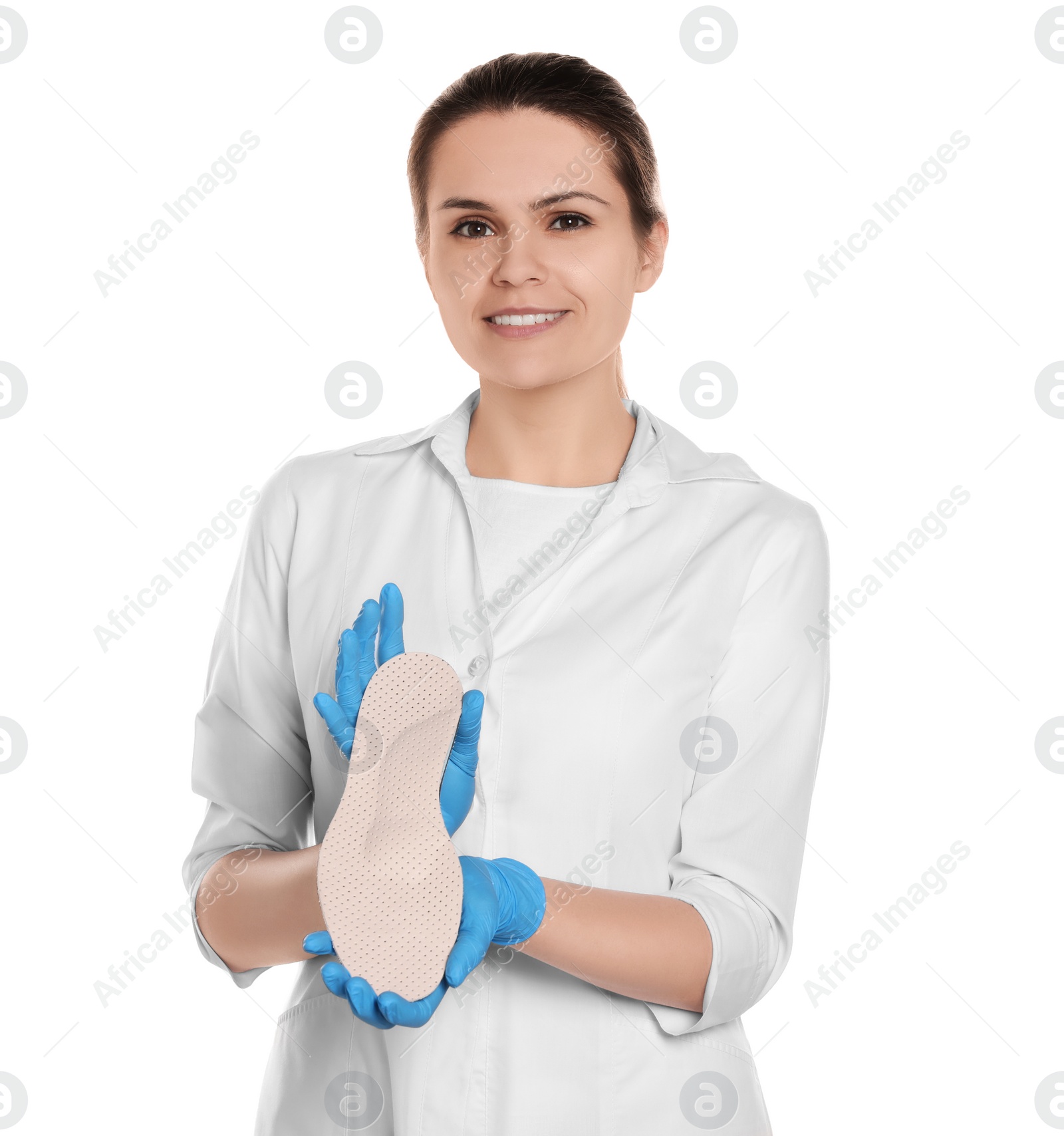 Photo of Beautiful female orthopedist showing insole on white background